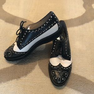 Michael Kors cream and black shoes with silver studs.